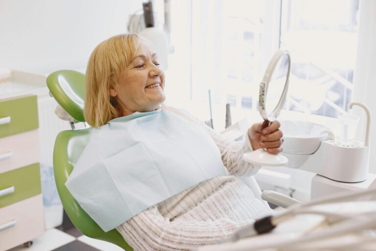 Woman smiling while receiving orthodontic treatment