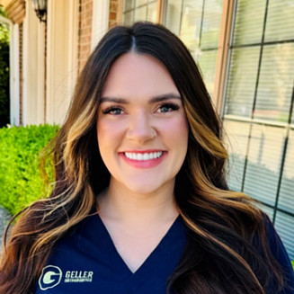 Alexia, Dr. Bean's treatment coordinator, pictured in blue scrubs.