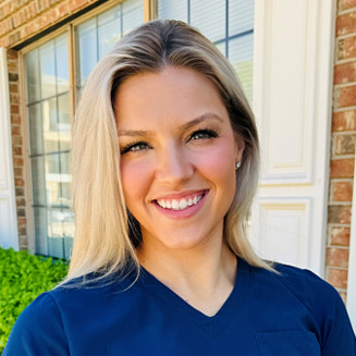 Madeline, Dr. Bean's scheduling coordinator, pictured in blue scrubs.