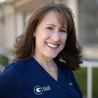 Sandi, Dr. Bean's clinical coordinator, pictured in blue scrubs.