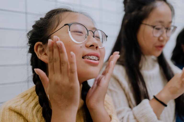 Two young people with braces and glasses in a dentistry office