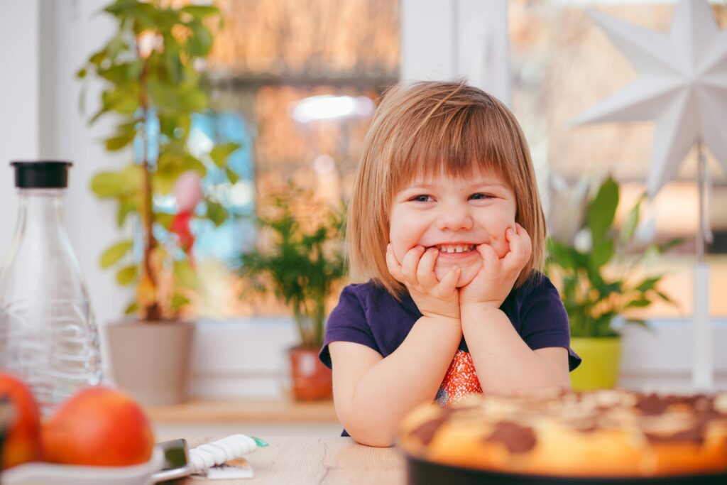 Smiling child at orthodontic appointment for early braces evaluation