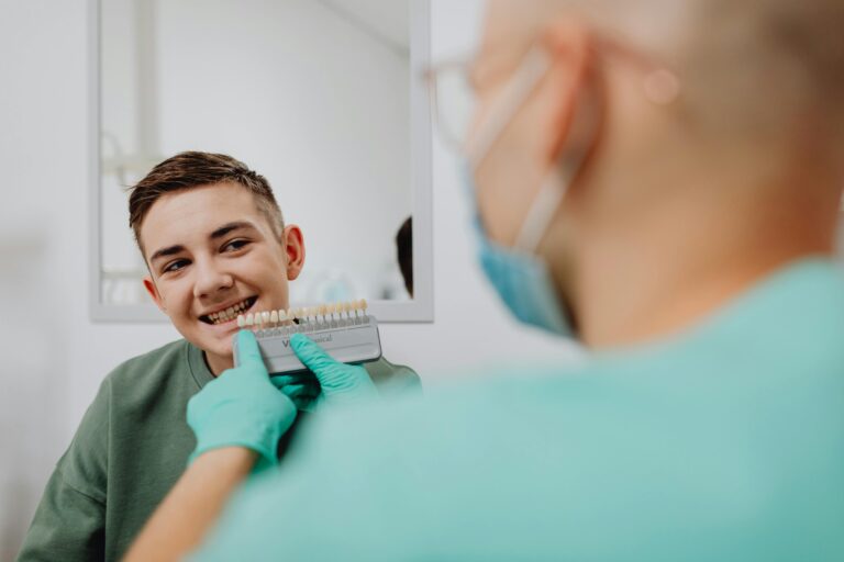 Smiling teenager with braces during orthodontic appointment