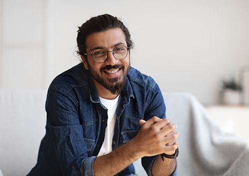 Man with either an overbite or overjet smiling happily.