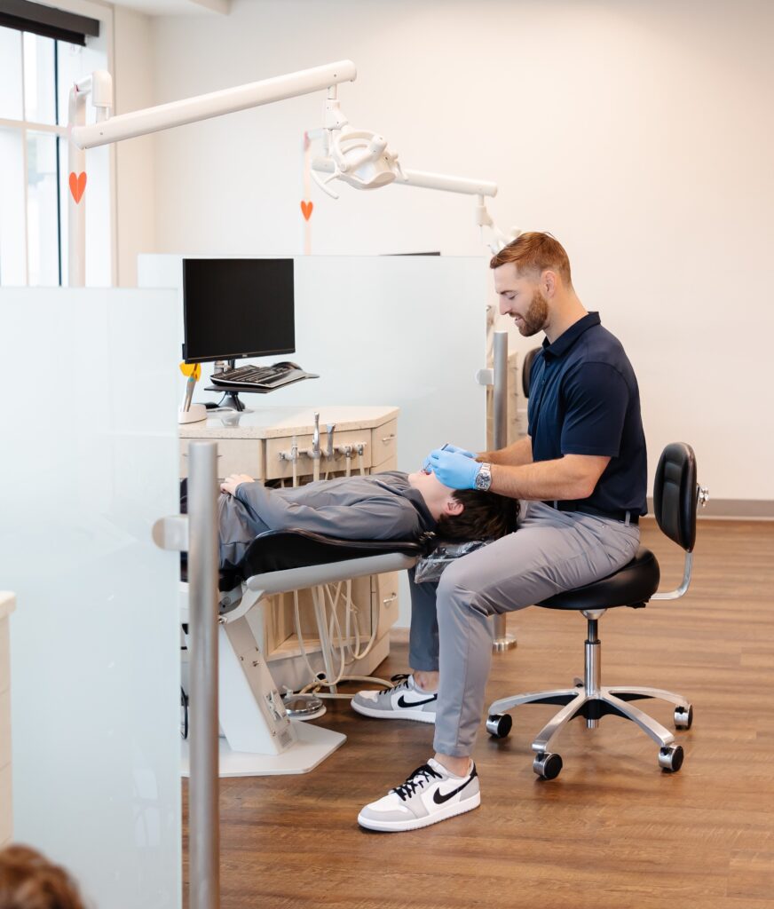 Dr. Bean providing personalized orthodontic care to patient in state-of-the-art treatment room at Bean Orthodontics in Plano, Texas