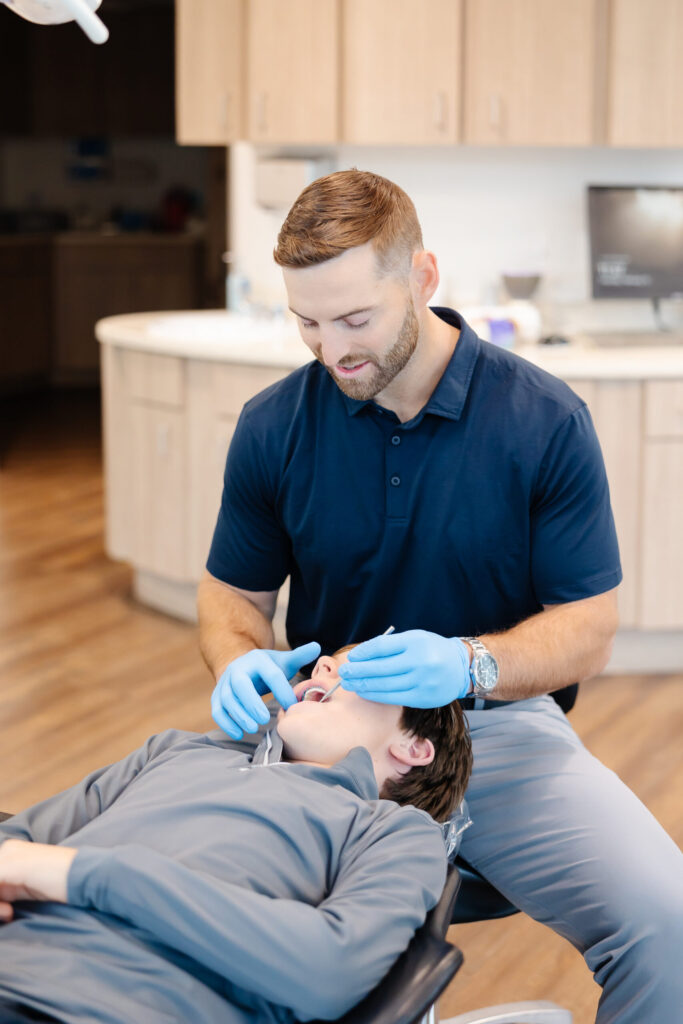 Dr. Bean providing personalized orthodontic care to young patient in Plano, Texas Office